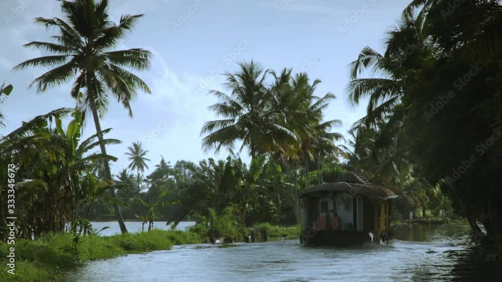 A houseboat drifts down the Kerala backwaters of India.
A houseboat drifts down the Kerala backwaters of India.