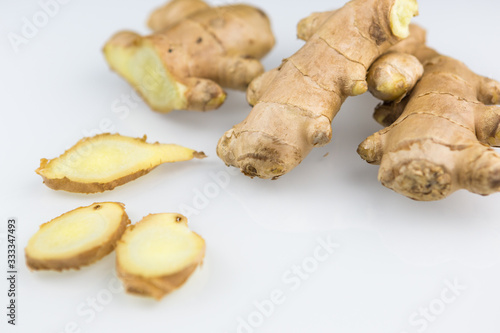 Fresh organic root ginger with slices isolated on white background. Natural anti virus medicine supports immune system