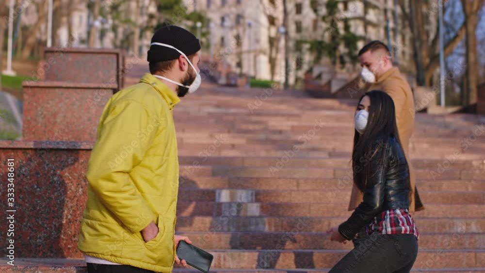 In the middle of the street group of young people a couple and a guy with a protective mask they are arguing they get nervous on the quarantine time of the Coronavirus mers. Shot on ARRI Alexa Mini In the middle of the street group of young people a couple and a guy with a protective mask they are arguing they get nervous on the quarantine time of the Coronavirus mers. Shot on ARRI Alexa Mini