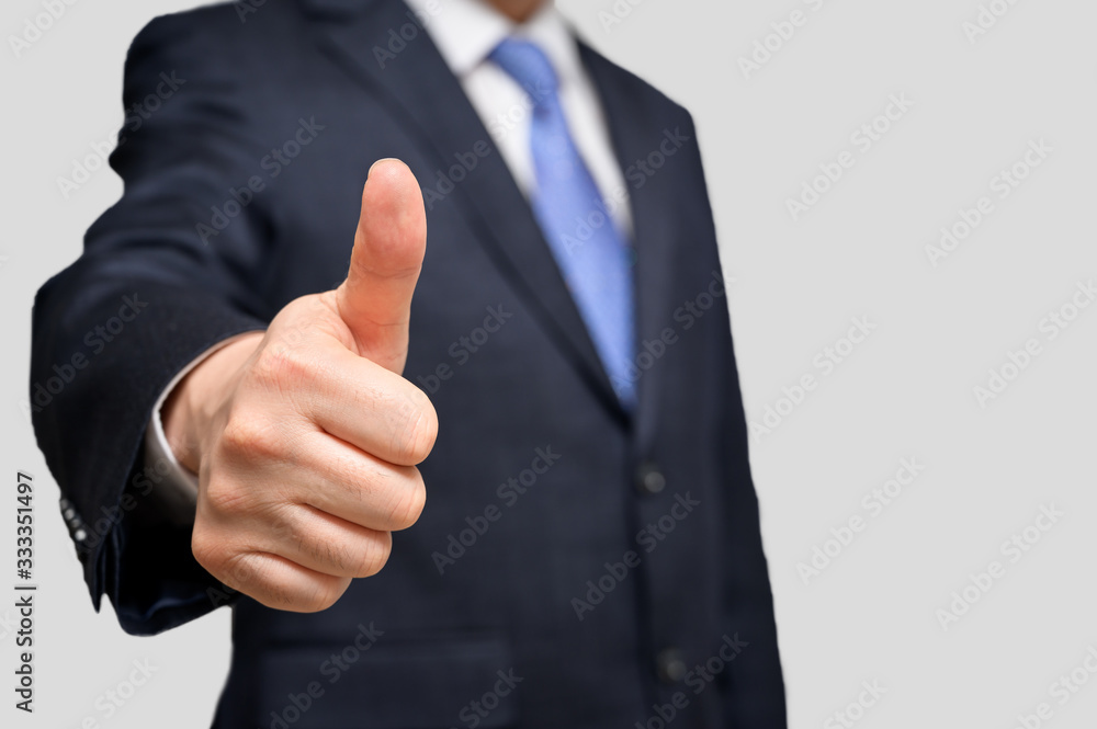 A businessman doing thumbs up. With copy space. A businessman doing thumbs up. With copy space.