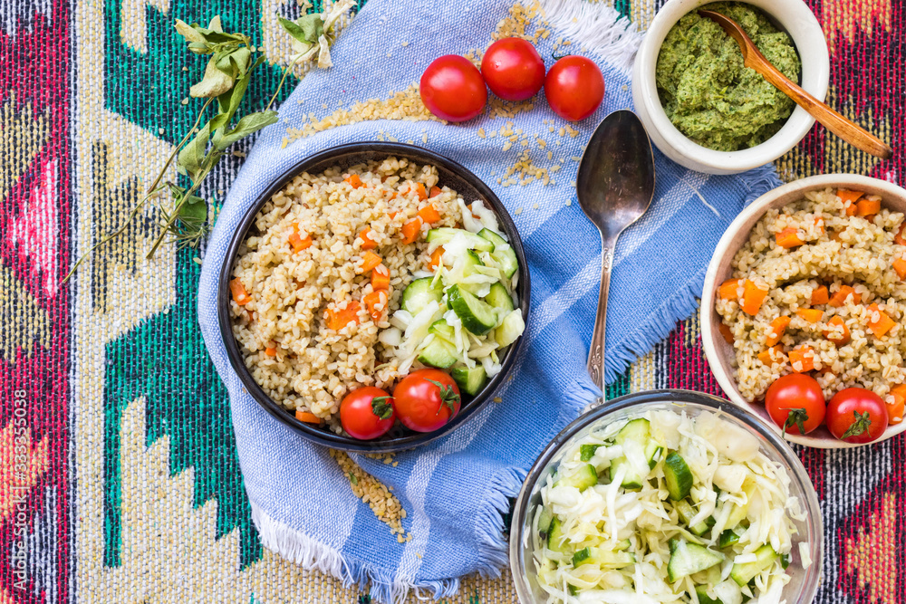 Vegetable bulgur pilaf or pulao. Turkish or Levantine Arabic durum wheat cooked grain as part of vegan, vegetarian healthy diet food. Vegetable bulgur pilaf or pulao. Turkish or Levantine Arabic durum wheat cooked grain as part of vegan, vegetarian healthy diet food.
