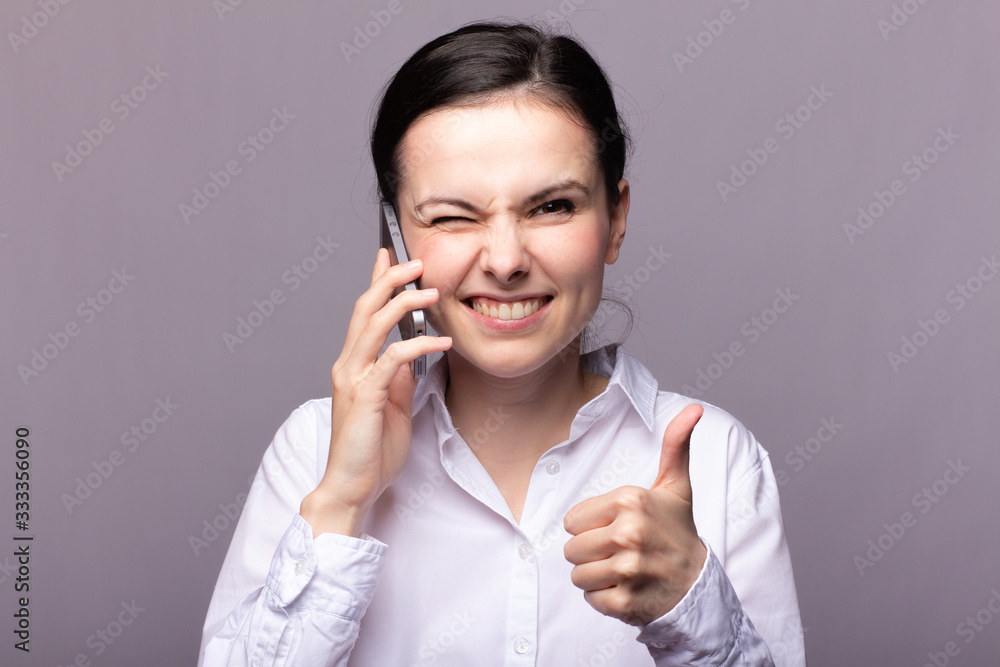 girl in a white shirt communicates on the phone girl in a white shirt communicates on the phone