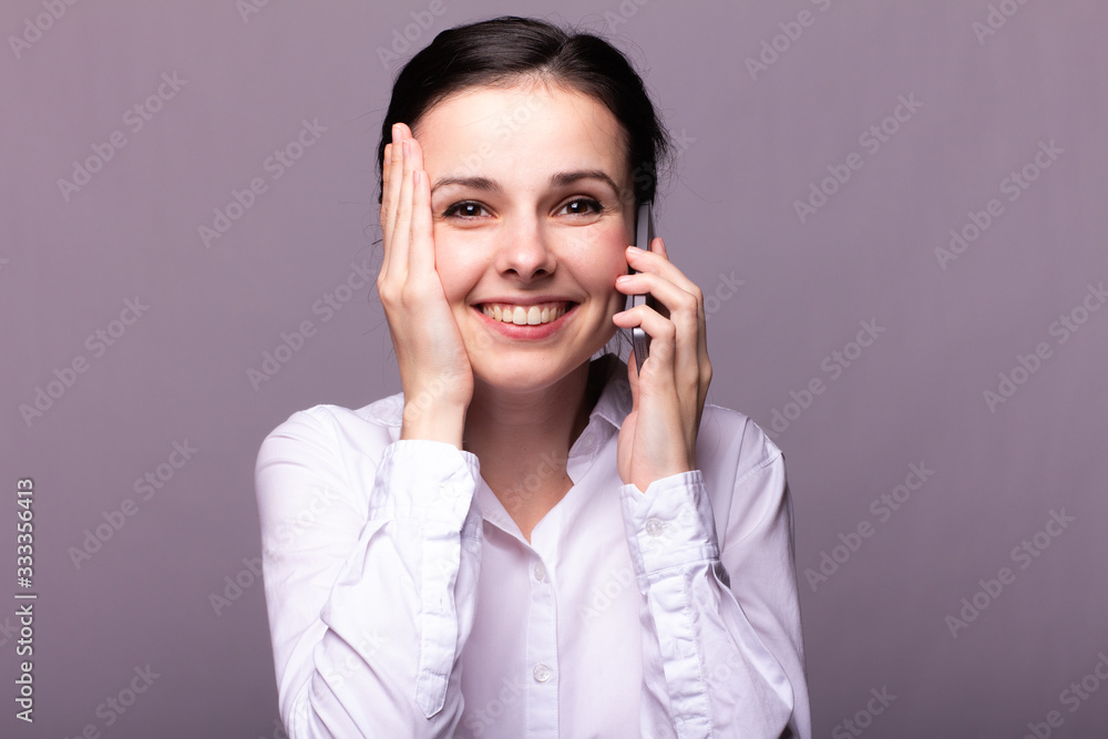 girl in a white shirt communicates on the phone girl in a white shirt communicates on the phone