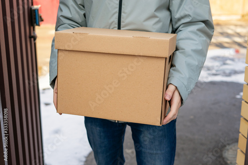 Delivery man holding cardboard boxes . Fast and free Delivery transport . Online shopping and Express delivery © murziknata