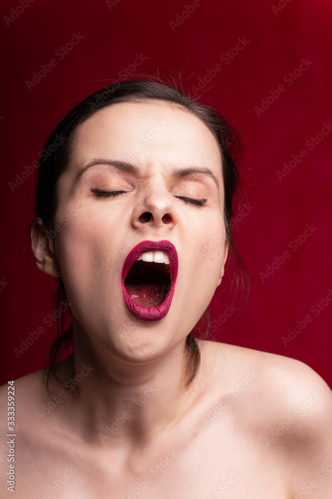 beautiful girl with red lipstick on her lips, red background beautiful girl with red lipstick on her lips, red background