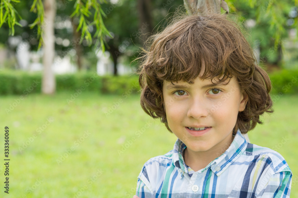 Little Boy walking in the park on a summer day Little Boy walking in the park on a summer day