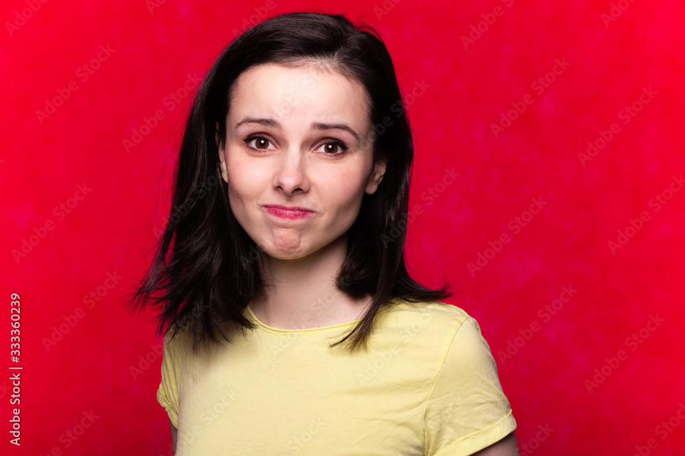 beautiful girl in a yellow t-shirt on a red background beautiful girl in a yellow t-shirt on a red background