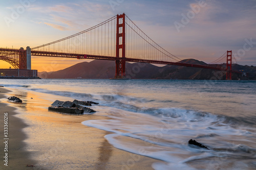 Sunset at the beach by the Golden Gate Bridge in San Francisco California