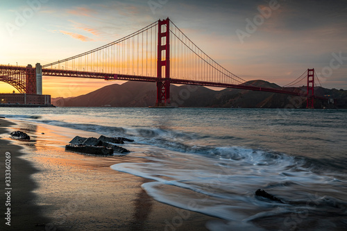 Sunset at the beach by the Golden Gate Bridge in San Francisco California