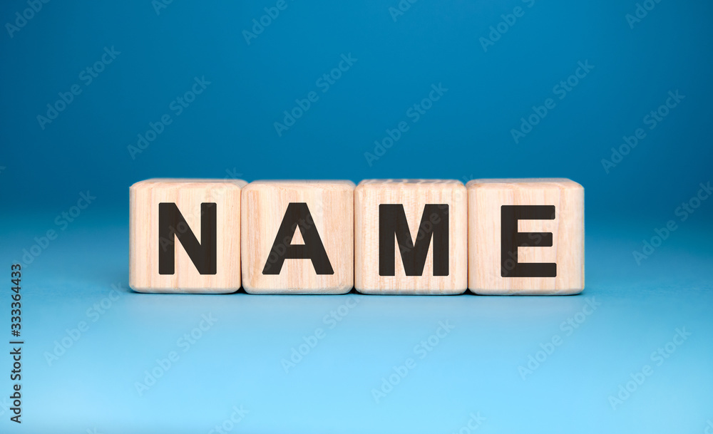 Fototapeta premium NAME - text on wooden blocks, concept, blue background