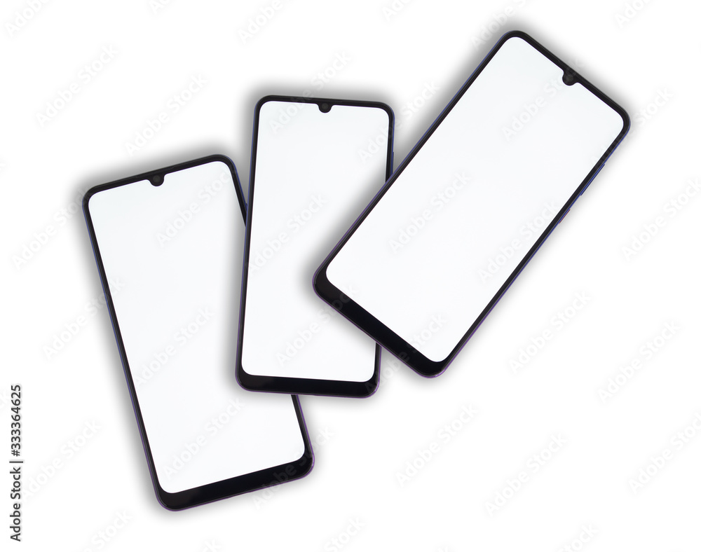 Three smartphones lie on one another with a white display on a light isolated background.