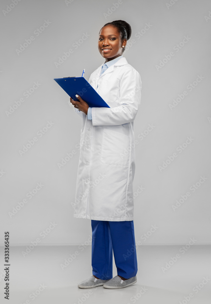 medicine, profession and healthcare concept - smiling african american female doctor or scientist in white coat with clipboard over grey background