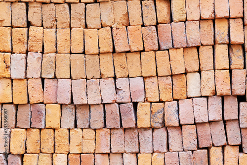 Stack of red clay bricks background