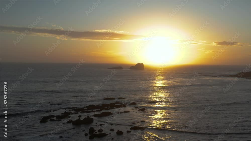Aerial drone descending shot of the sunset off of the coast of San Simeon, California, USA Aerial drone descending shot of the sunset off of the coast of San Simeon, California, USA