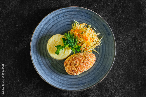 Top view of Kiev cutlet with mashed potato and pickled cabbage photo