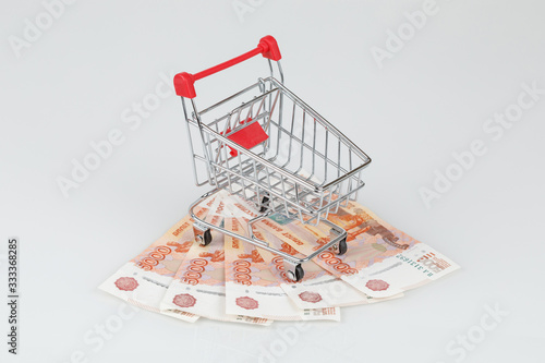 5000 russian rouble banknotes and shopping cart, financial crisis concept