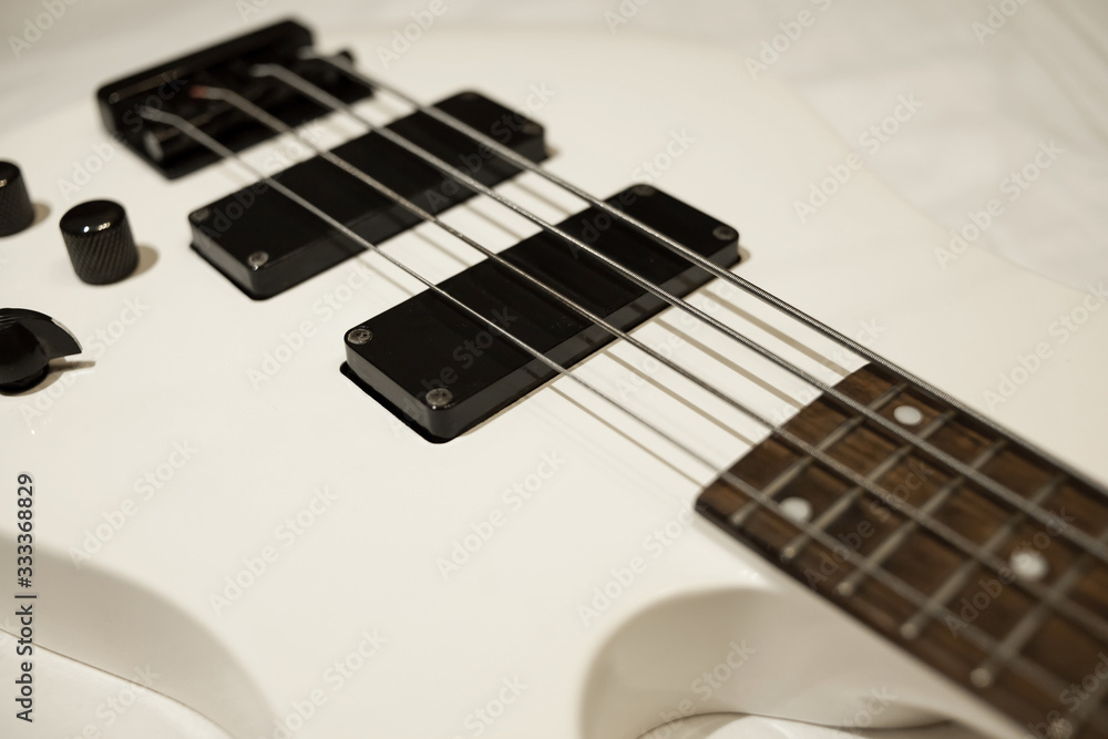 Fototapeta premium minimalism flat lay bass guitar isolated on white background