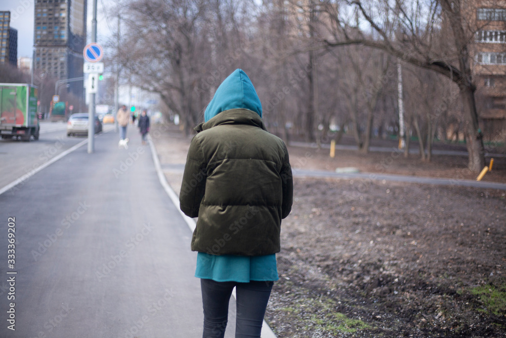 A girl is walking down the street. A girl is walking down the street.