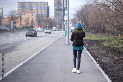 A girl is walking down the street. © Олег Копьёв