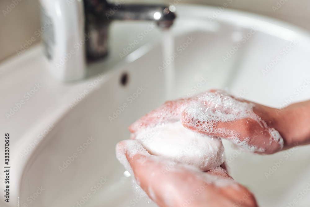 Fototapeta premium Man washing hands to protect against the coronavirus