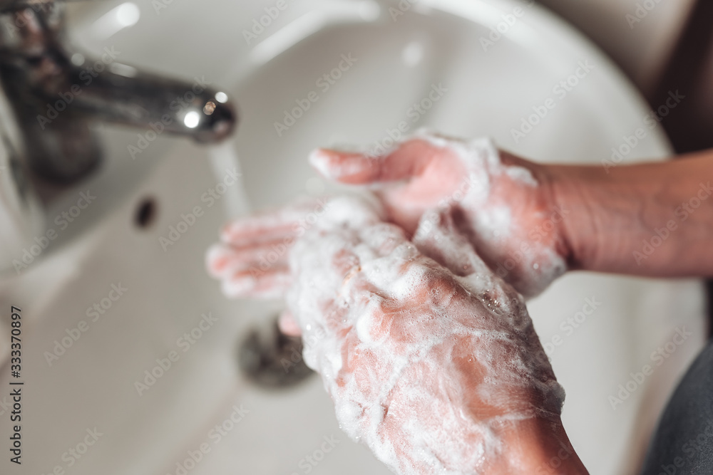 Man washing hands to protect against the coronavirus Man washing hands to protect against the coronavirus