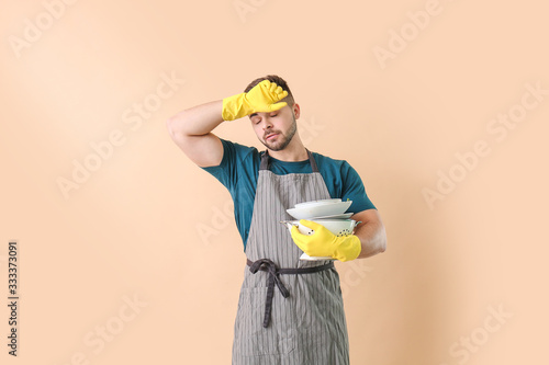 Tired man with dirty dishes...