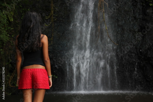 Waterfall and woman Tahiti alone