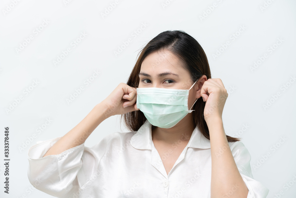 White shirt, woman wearing a medical mask to prevent the flu and Covid-19 corona virus, hand grips, ear strap White shirt, woman wearing a medical mask to prevent the flu and Covid-19 corona virus, hand grips, ear strap