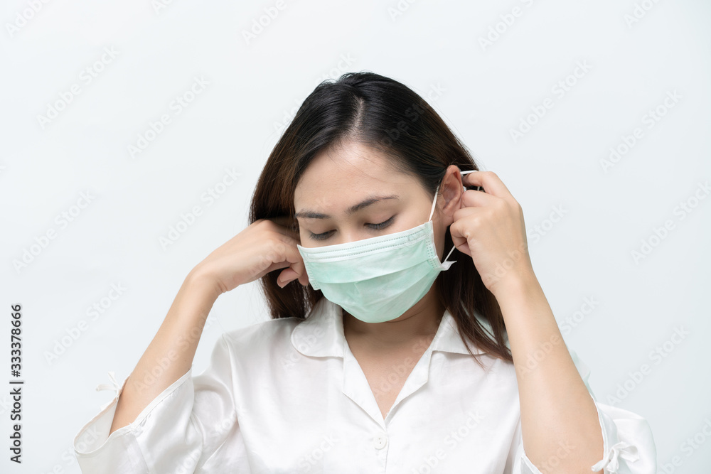 Woman white shirt, bent face wearing medical masks to prevent flu and Covid-19 coronary virus, hand grip, ear strap Woman white shirt, bent face wearing medical masks to prevent flu and Covid-19 coronary virus, hand grip, ear strap