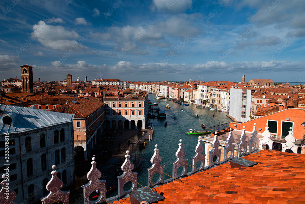 Top view of the Grand Canal from the roof of a building in Venice. Orange roofs, gondolas and boats. Architecture and Tourism