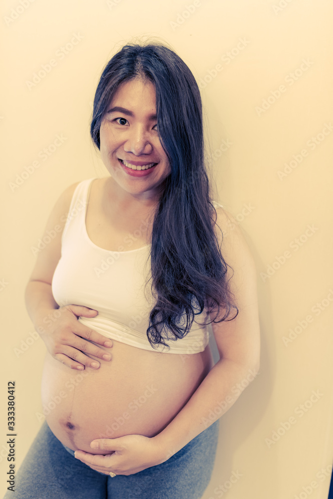 Pregnant woman feeling happy at home while taking care of her child. Maternity prenatal care and woman pregnancy concept. Pregnant woman feeling happy at home while taking care of her child. Maternity prenatal care and woman pregnancy concept.