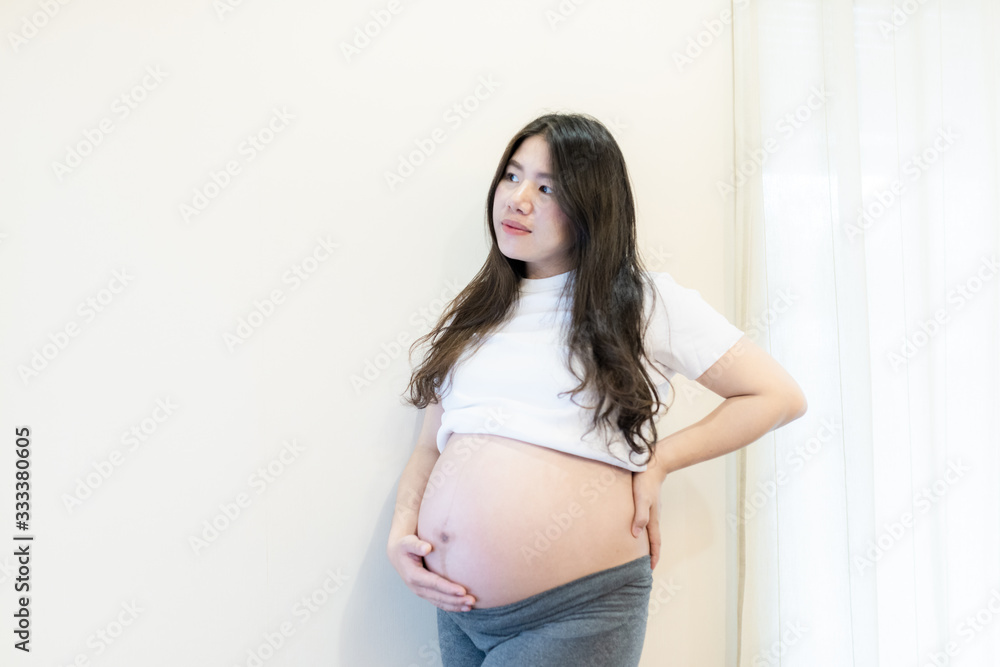 Pregnant woman feeling happy at home while taking care of her child. Maternity prenatal care and woman pregnancy concept. Pregnant woman feeling happy at home while taking care of her child. Maternity prenatal care and woman pregnancy concept.
