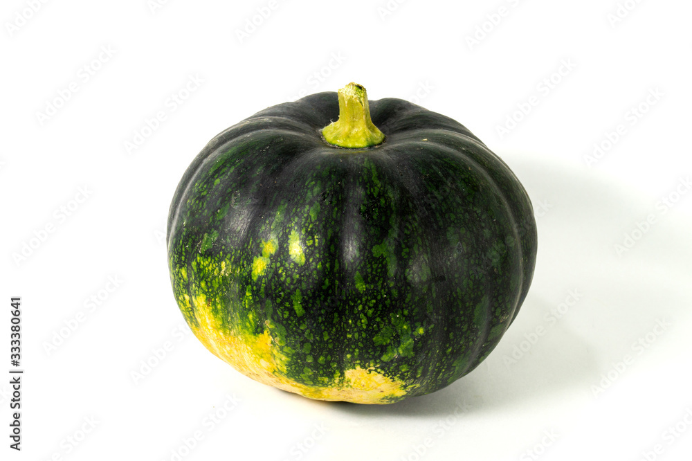 A green natural fresh Indian pumpkin is isolated on middle of white background A green natural fresh Indian pumpkin is isolated on middle of white background
