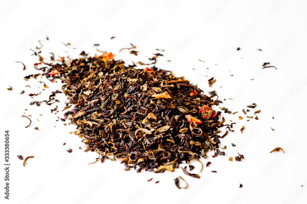 A mixture of black and green tea with vanilla-strawberry flavor, sliced strawberries and rose petals. Background for tea and antioxidants. A mixture of black and green tea with vanilla-strawberry flavor, sliced strawberries and rose petals. Background for tea and antioxidants.