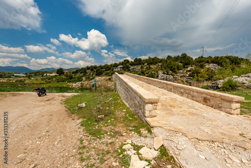 Seki, Elmalı - Antalya / Turkey. April 30, 2018. Xanthos river and historic Ottoman bridge at Urluca village near Fethiye town in Turkey. photo