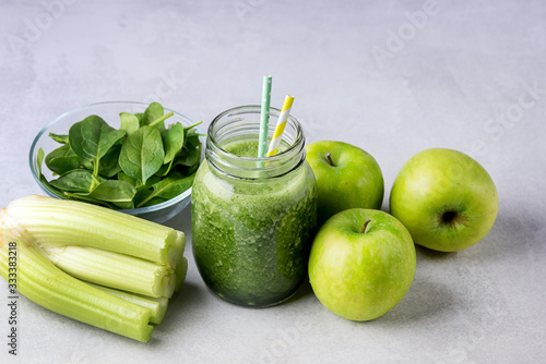 Glass Jar of Healthy Green Smoothie Detox Drink wirh Green Apple Celery and Raw Spinach Diet Beverage Horizontal