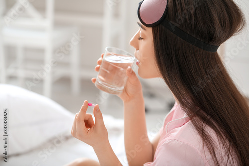 Young woman taking pills fo...