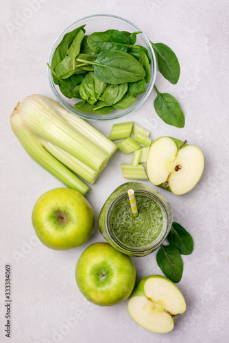 Glass Jar of Healthy Green Smoothie Detox Drink wirh Green Apple Celery and Raw Spinach Diet Beverage Vertical Top View