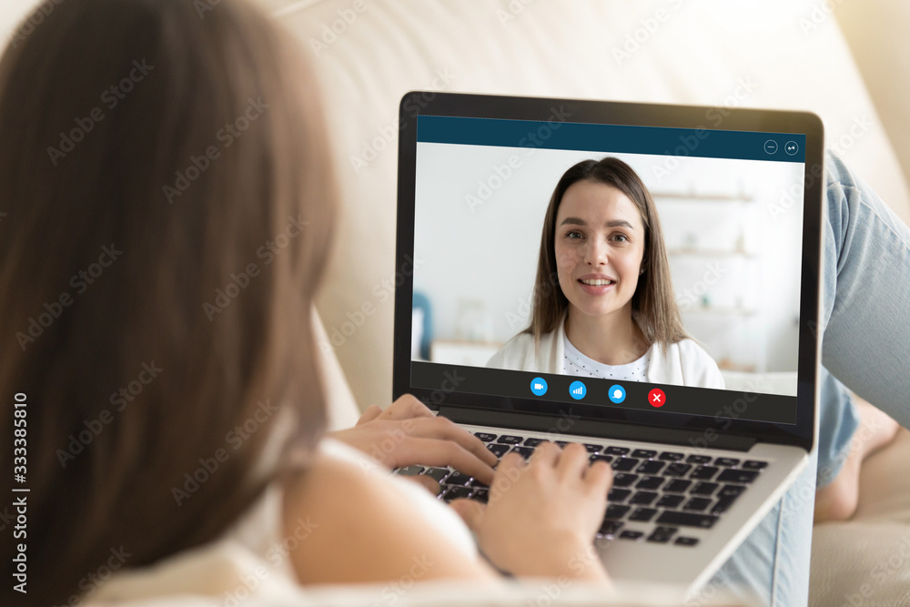 Head shot close up pc screen view attractive young woman chatting with female friend sister online, using videoconference computer application, distant internet communication preventing virus spread. Head shot close up pc screen view attractive young woman chatting with female friend sister online, using videoconference computer application, distant internet communication preventing virus spread.