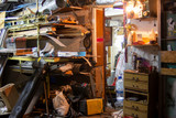 Big mess in an over stuffed suburban garage.
