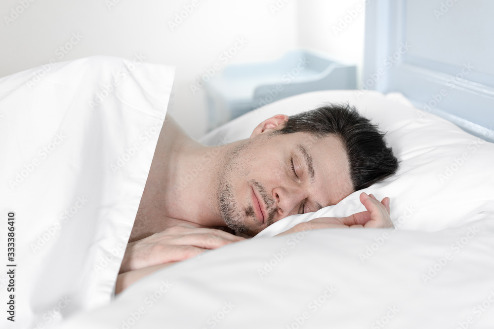 young man sleeping in bed young man sleeping in bed