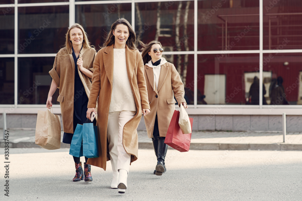Girls on a shopping. Friends walks. Women with a shopping bags.