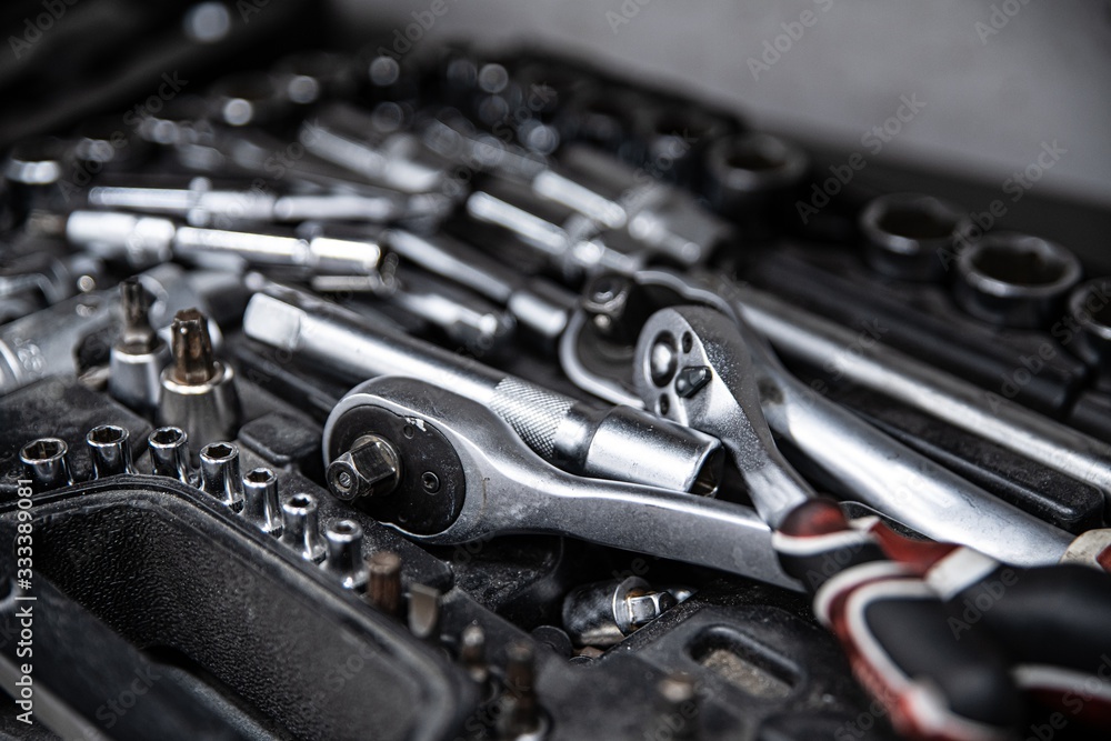 Dirty used wrench and tools in mechanic tool box