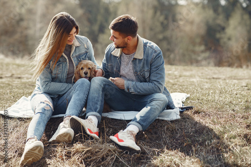 Woman in a jeans clothes. Couple in a spring forest. People with a cute dog.