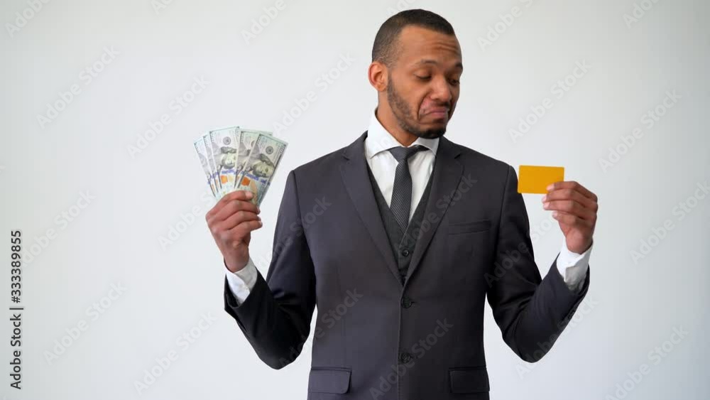 African-american Businessman making choice between Credit Card and money African-american Businessman making choice between Credit Card and money