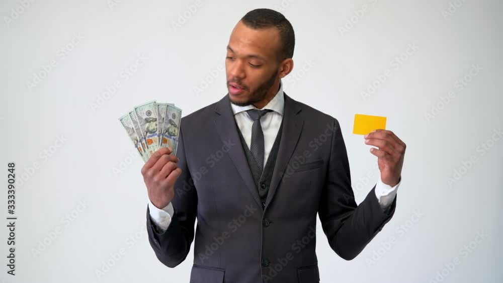African-american Businessman making choice between Credit Card and money African-american Businessman making choice between Credit Card and money