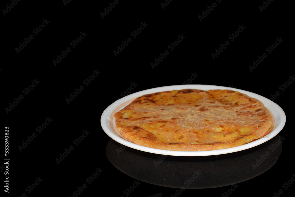 Aloo parantha in plate with black background Aloo parantha in plate with black background