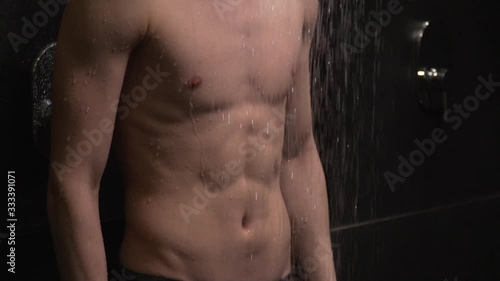 handsome guy washes in the shower