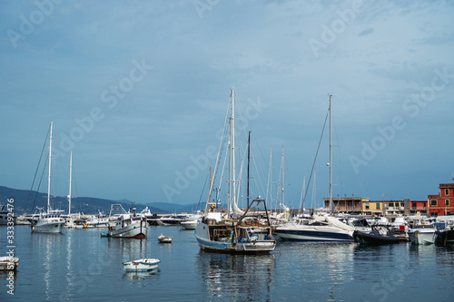 Wide panoramic view of luxury yachts and sailing boats moored in harbor of Santa Margherita Ligure, Italian Riviera. Beautiful mediterranean landscape with cloudy blue sky. © SeaRain