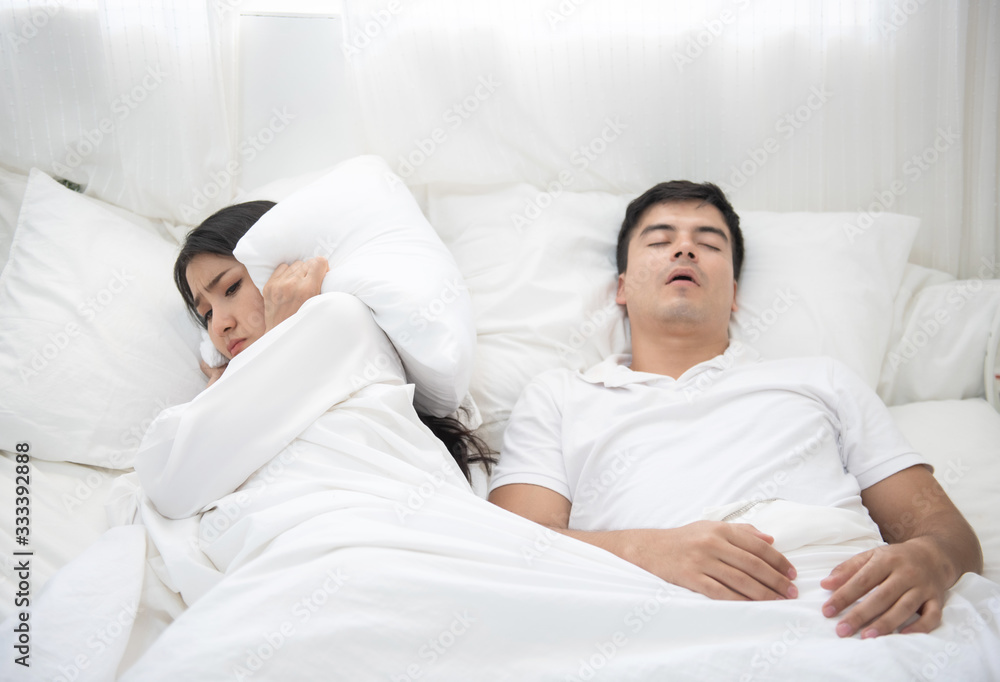 man snoring, woman can not sleep in bed at home. man snoring, woman can not sleep in bed at home.